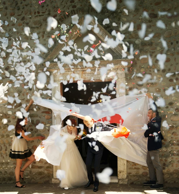 a bride and groom in front of confetti