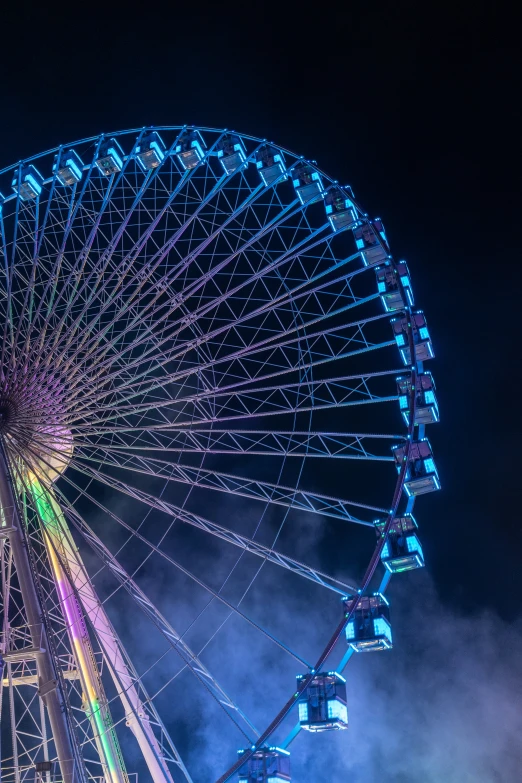 colorful lights on the ferris wheel at night