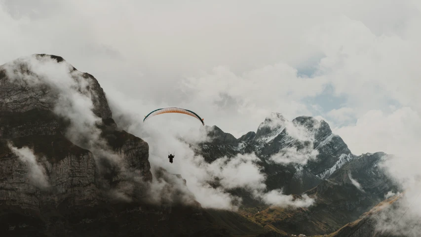 a po of mountains and a parasailing