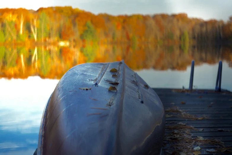 this is a boat docked at a pier by a lake