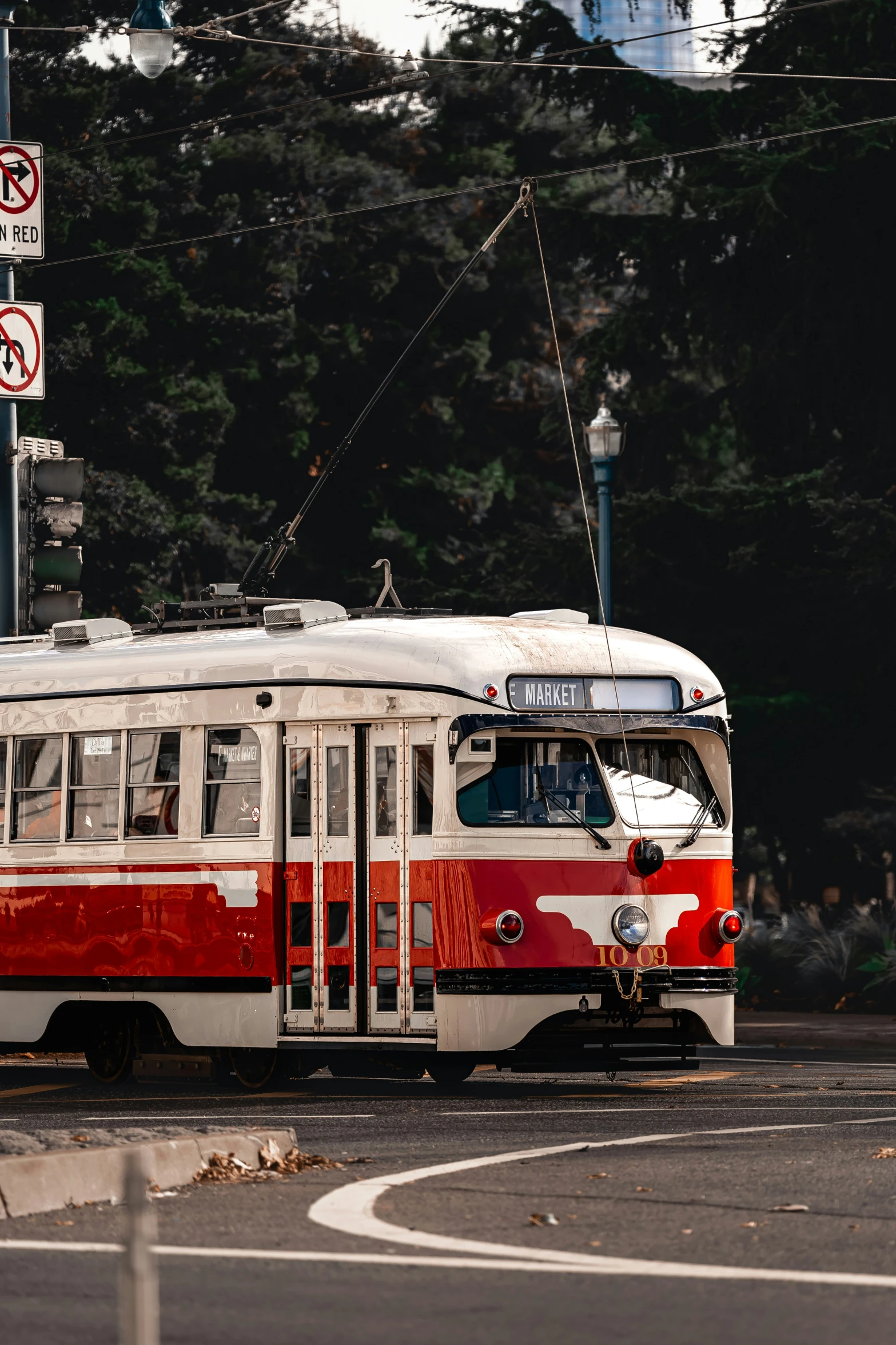 an orange and white bus driving through the intersection