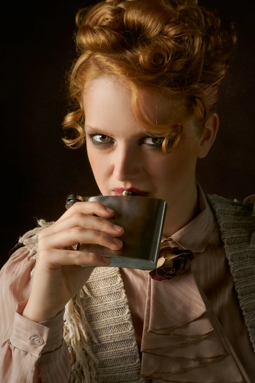 a woman with red hair is drinking from a coffee mug