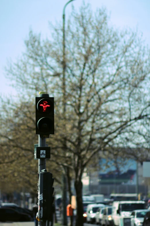 a traffic light next to a busy city street