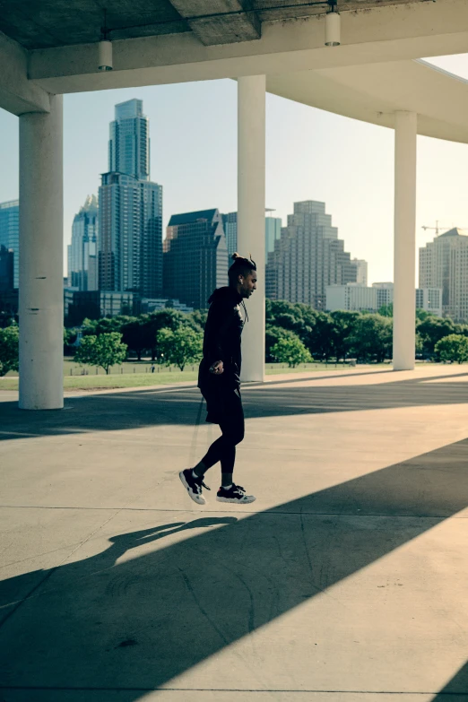 a young man is walking on a sunny day