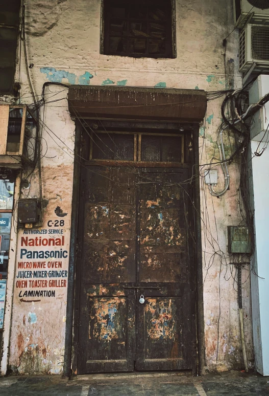 the wooden door to the building is covered with signs