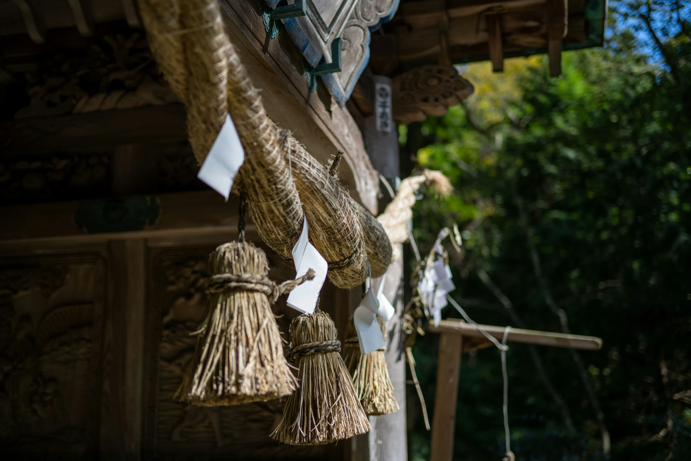 a group of woven items hangs from hooks