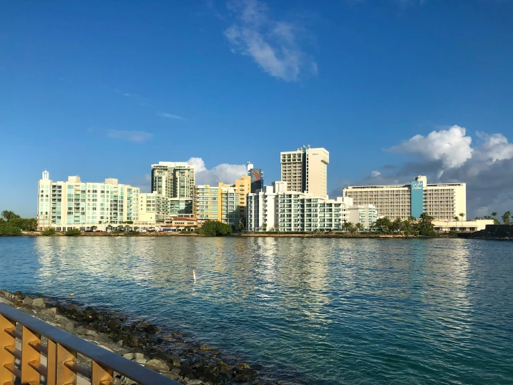 a city with lots of tall buildings behind a large body of water