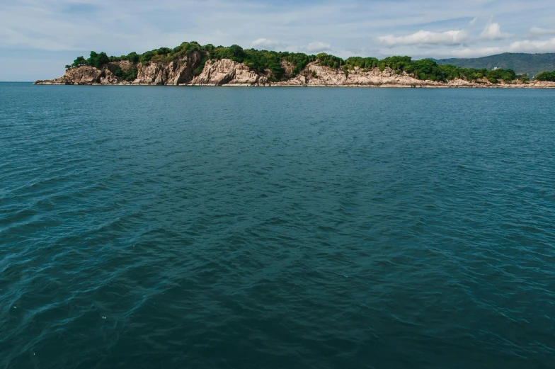 an island on the horizon of water