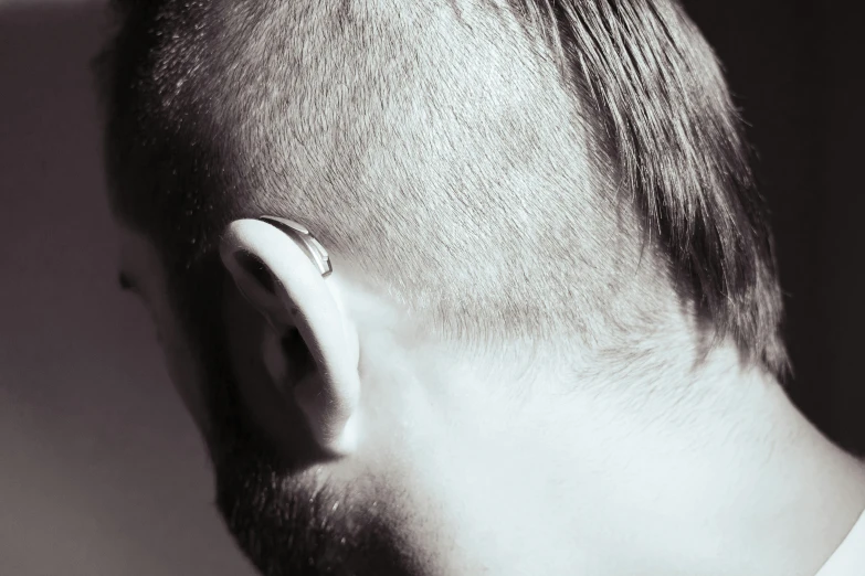 a person with a piercing on top of his ear