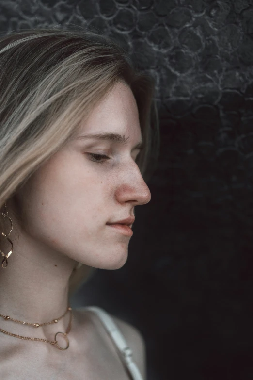 a beautiful woman with long blonde hair in a studio