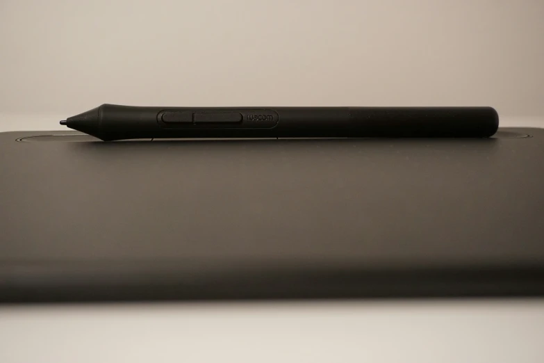 a pen resting on top of a laptop computer