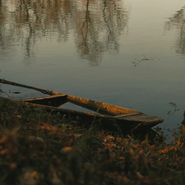 the empty canoe on the river bank has no rider on it