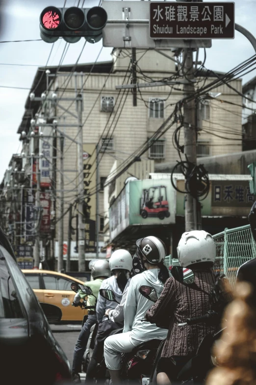 people on motorcycles on the street with vehicles in traffic