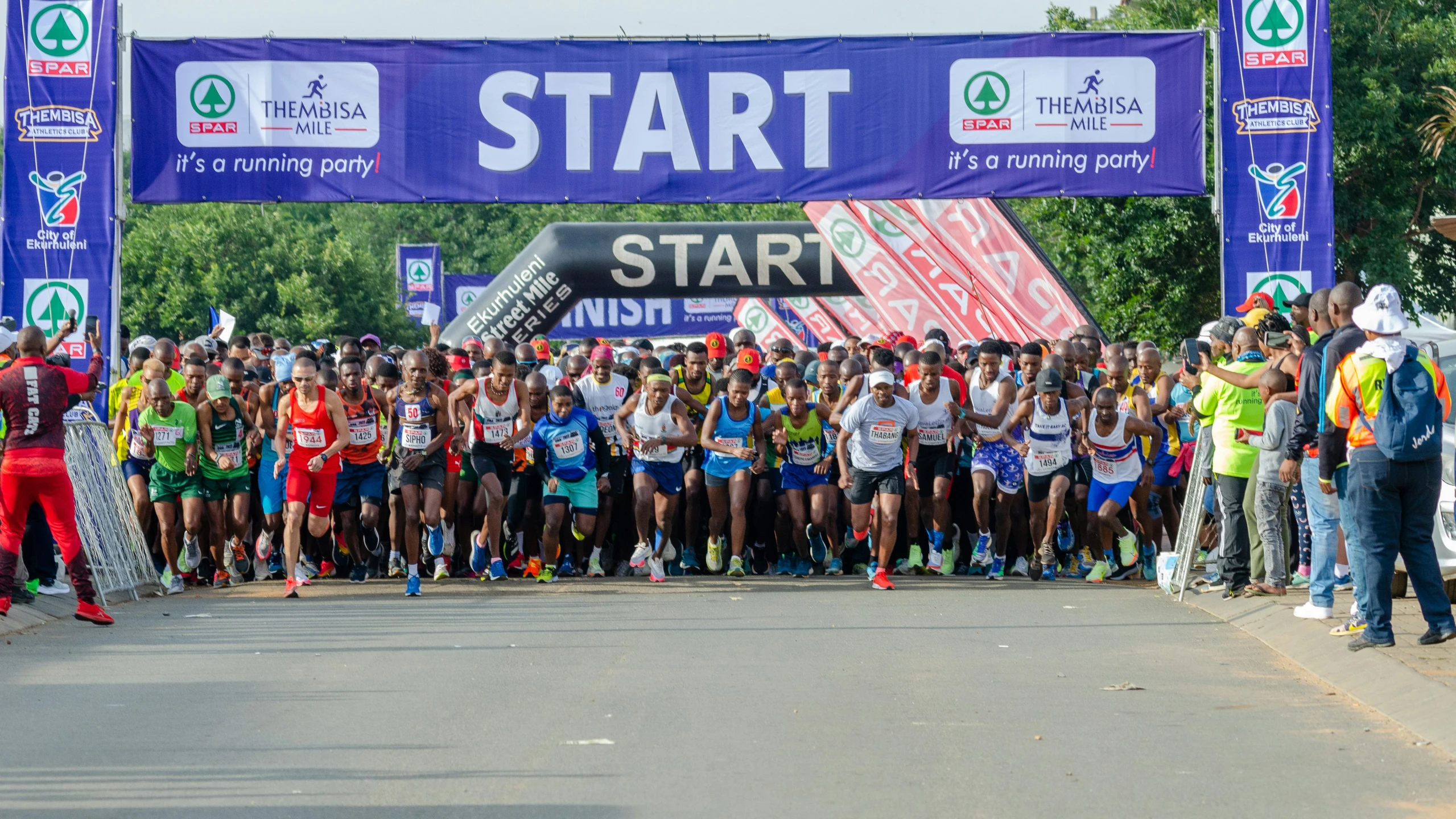 a large crowd of runners crossing the finish line