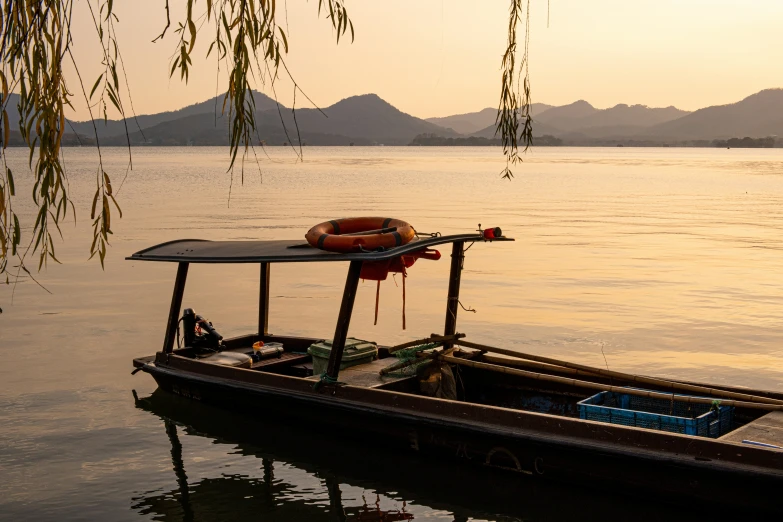 an empty boat with a raft attached is in the water