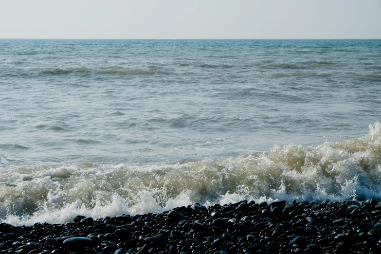 water and sand at the shore of an ocean