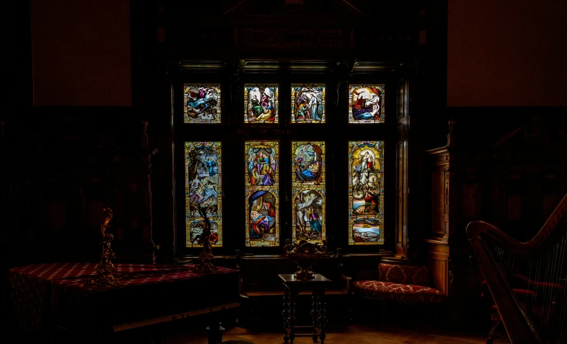 the windows inside a large building are painted with stained glass