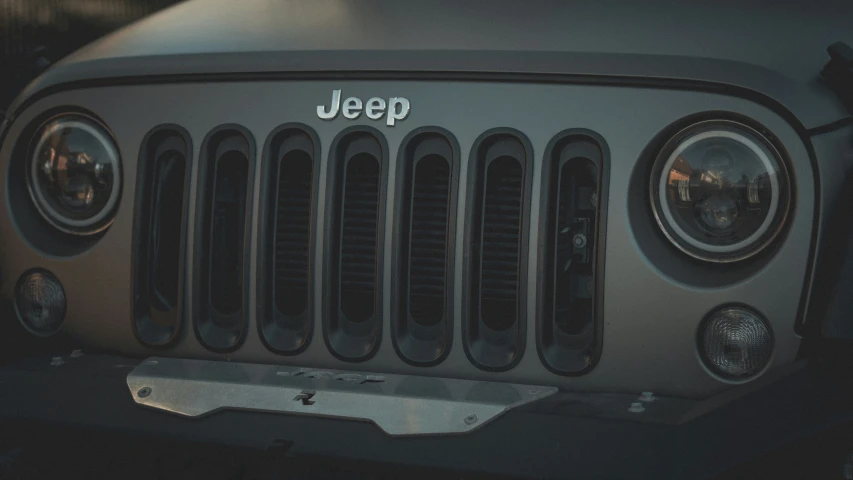 jeep grille on front of suv with headlight turned and the jeep grill visible