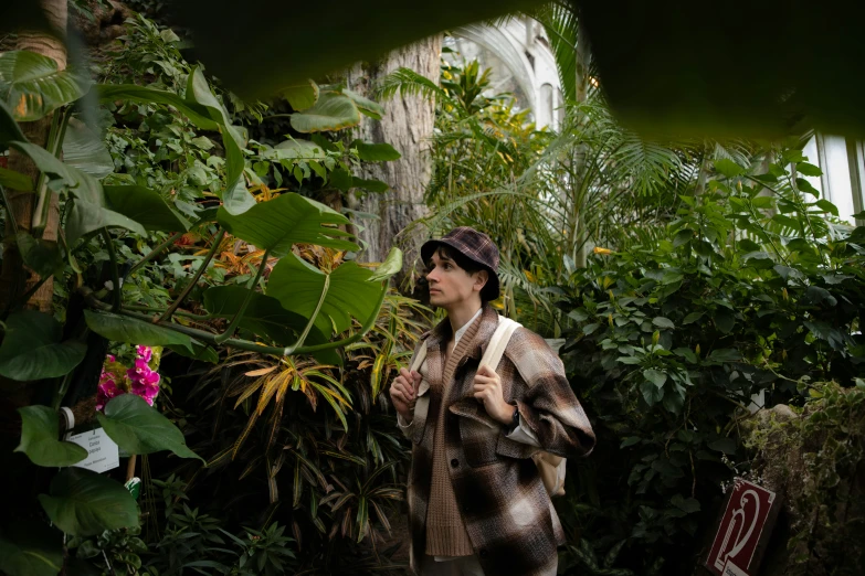 a woman in a tropical scene holding a handbag