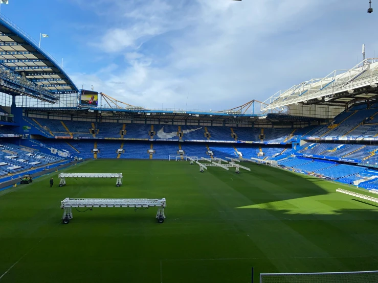 a large soccer field with chairs on each side