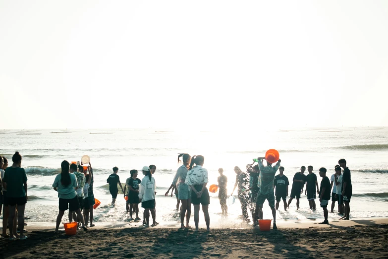 a group of people with surfboards on the beach