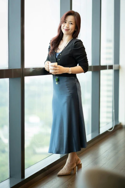 a woman is posing for the camera on the glass wall