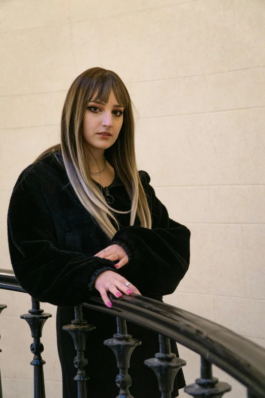 a woman leaning on some railing while posing for a picture