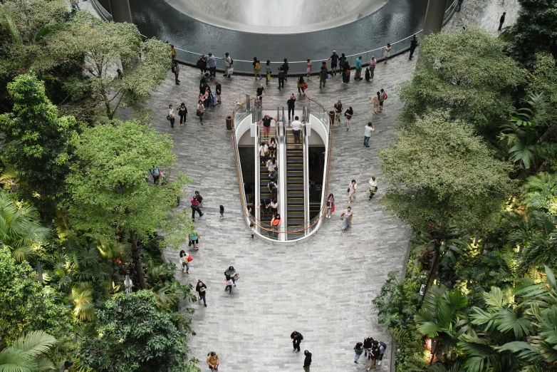 people walking up steps to a waterfall on a cloudy day