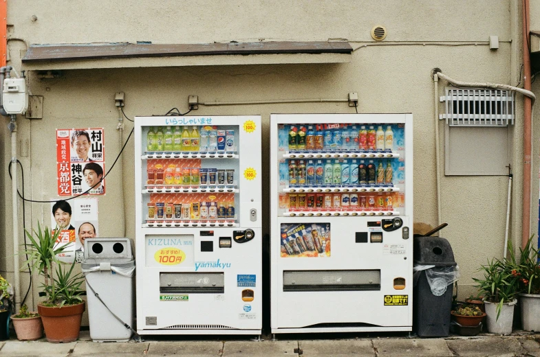 a street scene with a vending machine and a garbage can