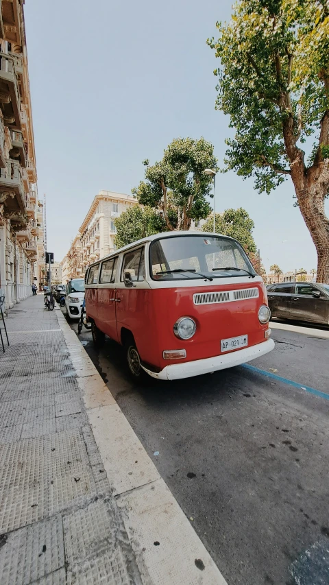 a red and white bus parked on the side of the street