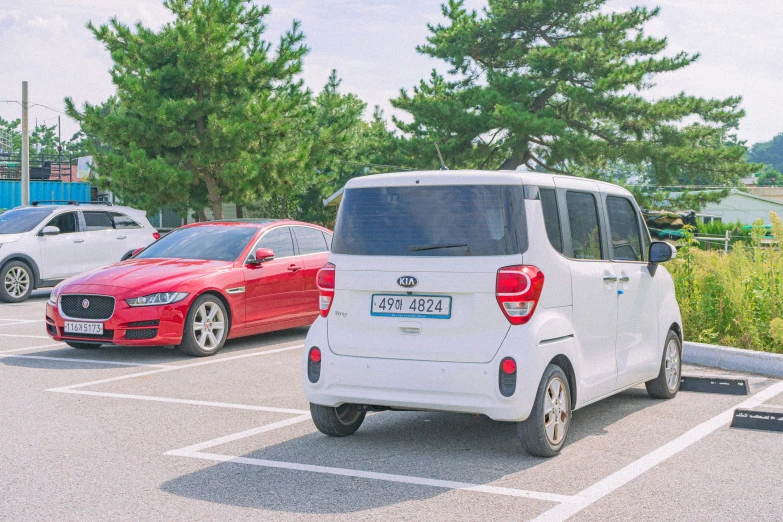 several cars are parked in an empty parking lot