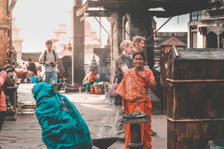 people stand on the street next to a large piece of equipment