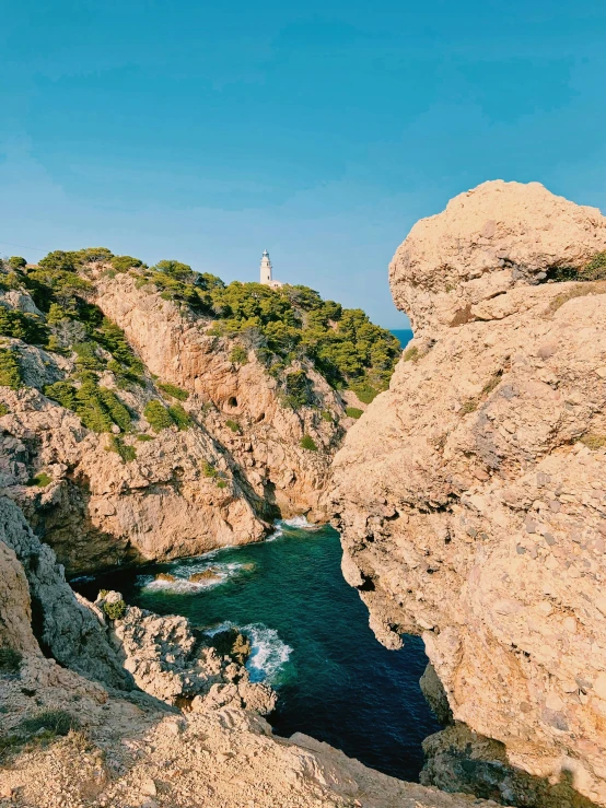 view from a cave looking over a body of water and rock