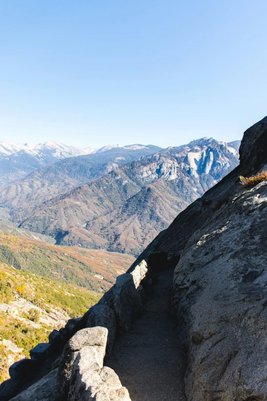 an empty rocky trail going up the side of a mountain