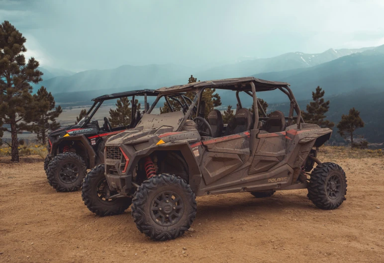 four atv utv on dirt near mountains