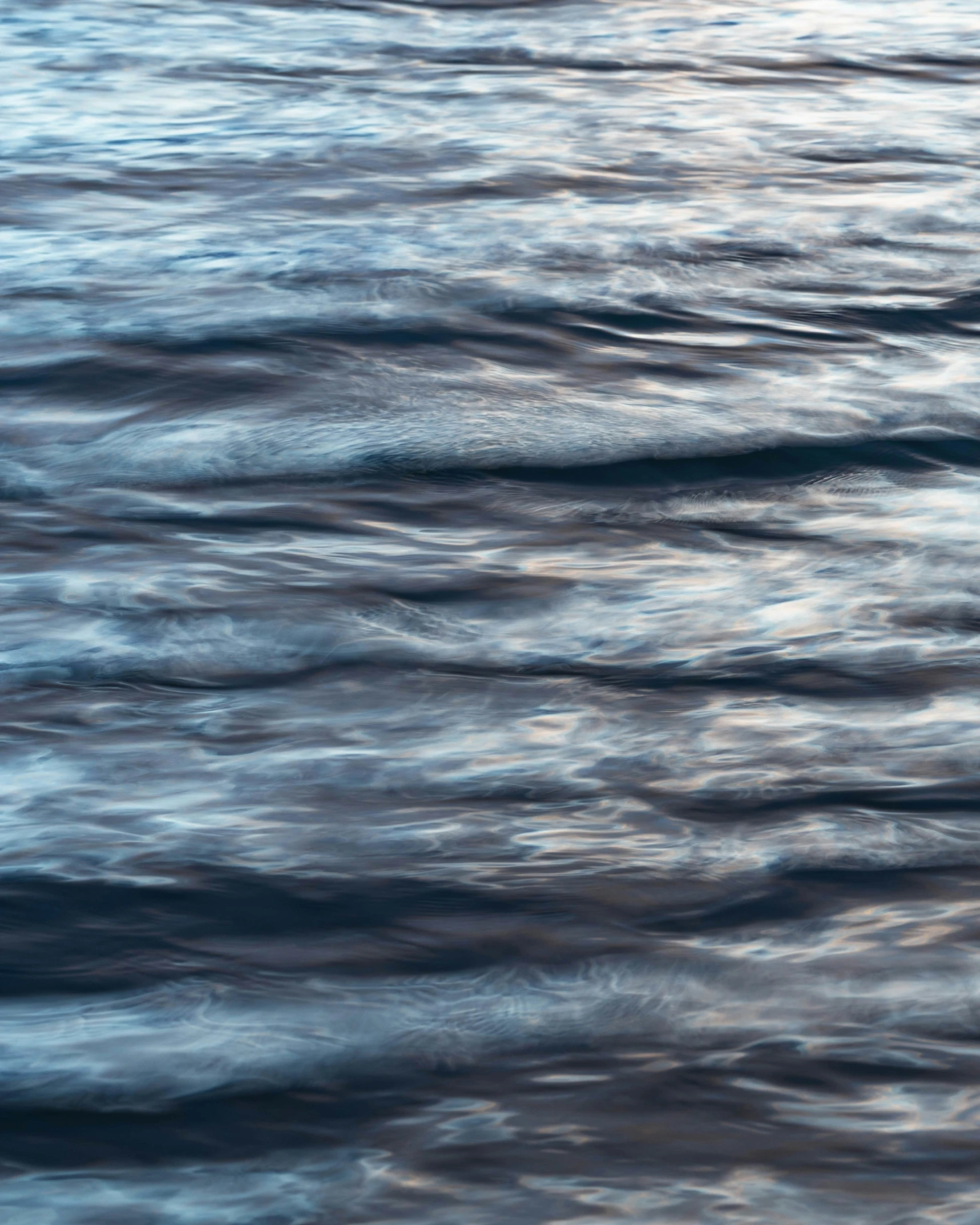 a large body of water sitting under a cloudy sky