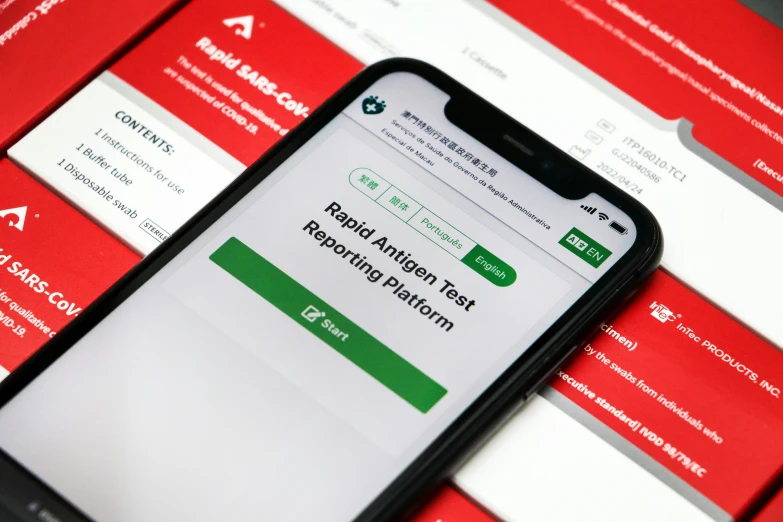 a black cell phone is sitting on a red background