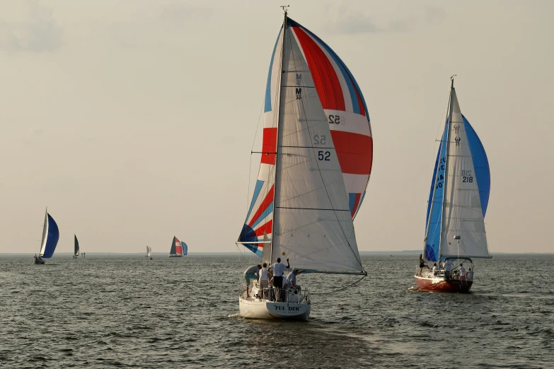 sailboats sail in the ocean on the water