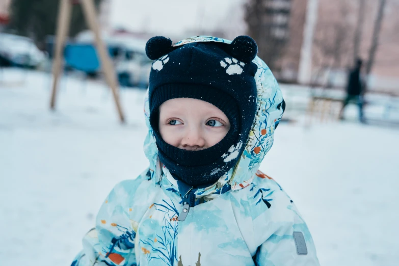 a young person in winter clothing in the snow