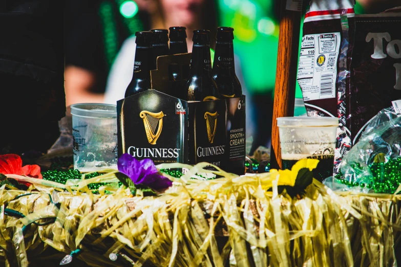 bottles of guinness, sprinkles and straw on the table