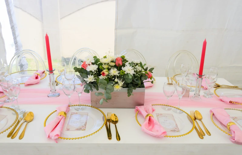 the place settings are laid out on the table with flowers