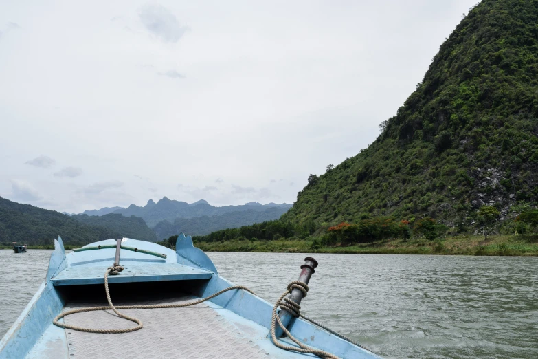 the inside of a small wooden boat on a river