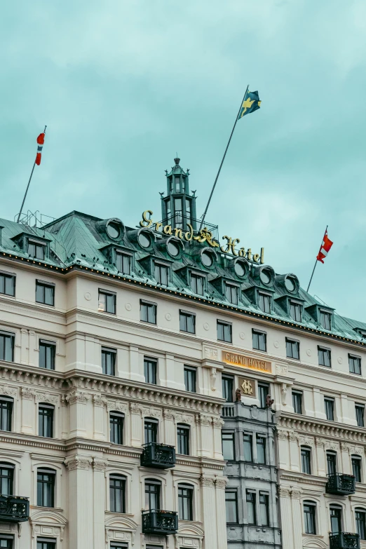 a large beige building with many flags flying in the air