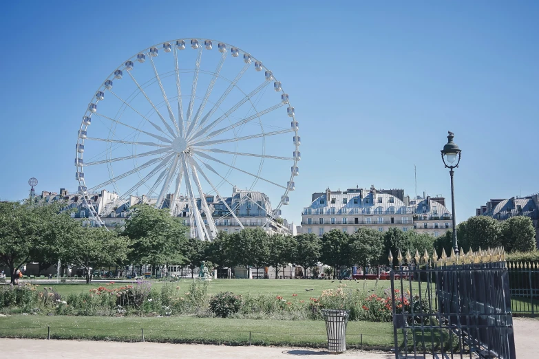 a ferris wheel in the distance with a building on the background