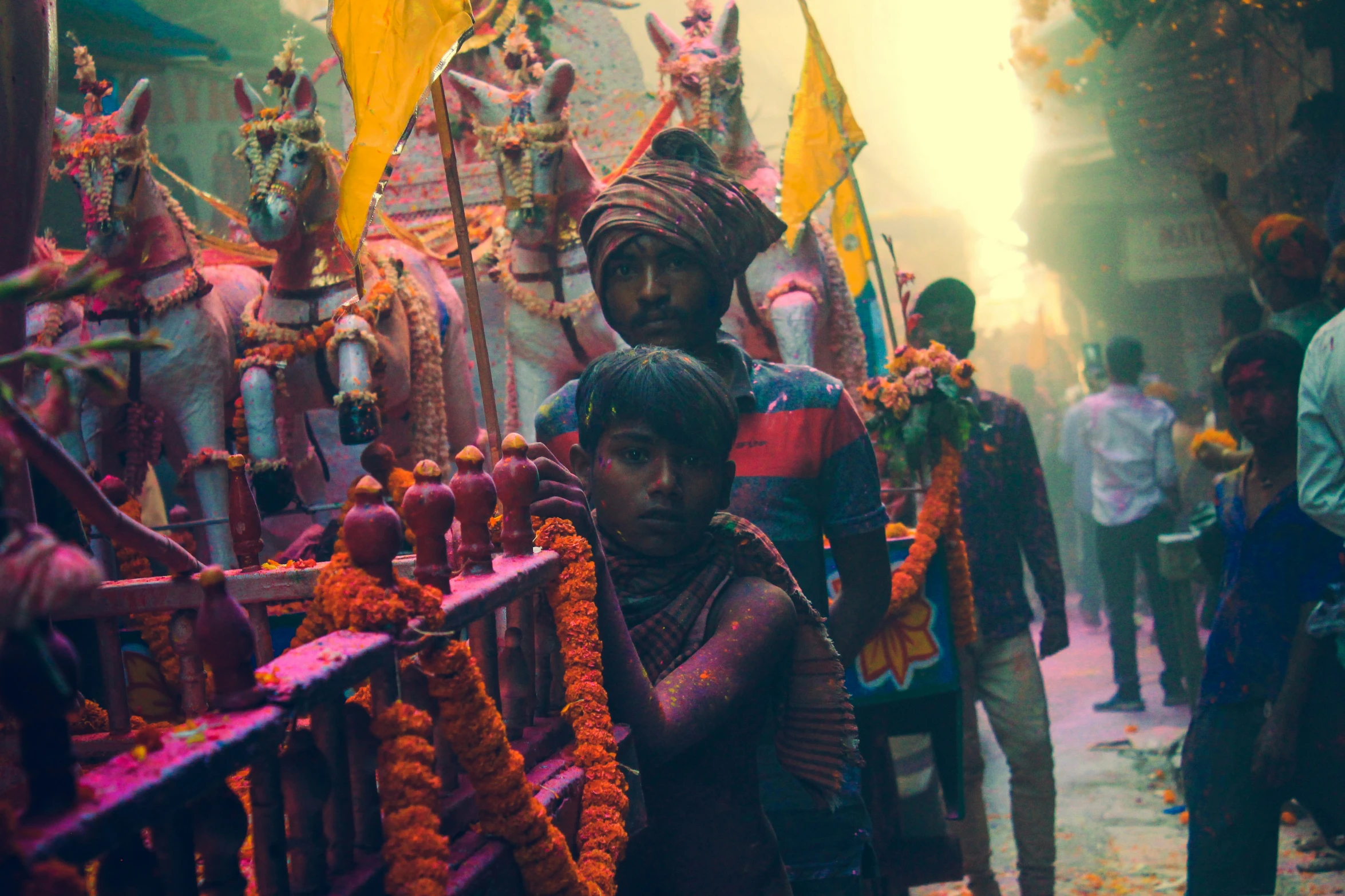 an indian man and child are standing in front of a cart