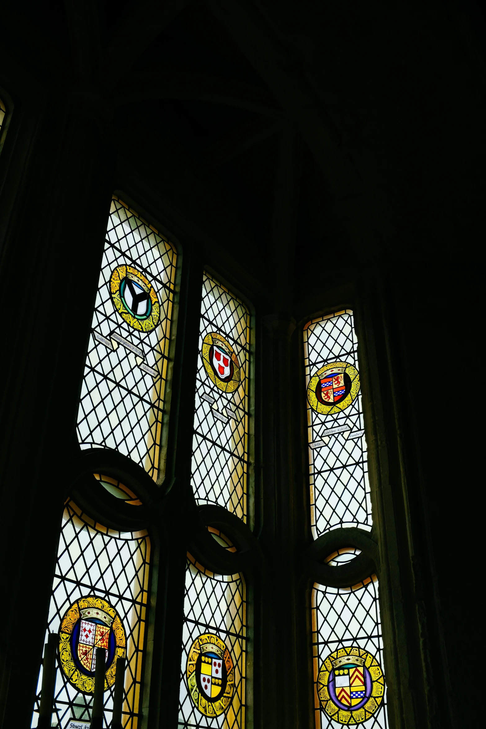 two stained glass windows in the center of a wall