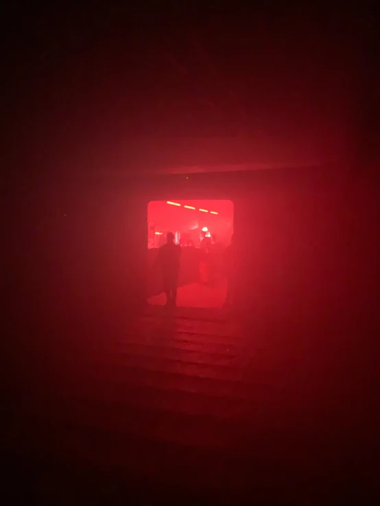 people standing outside a fire escape at night