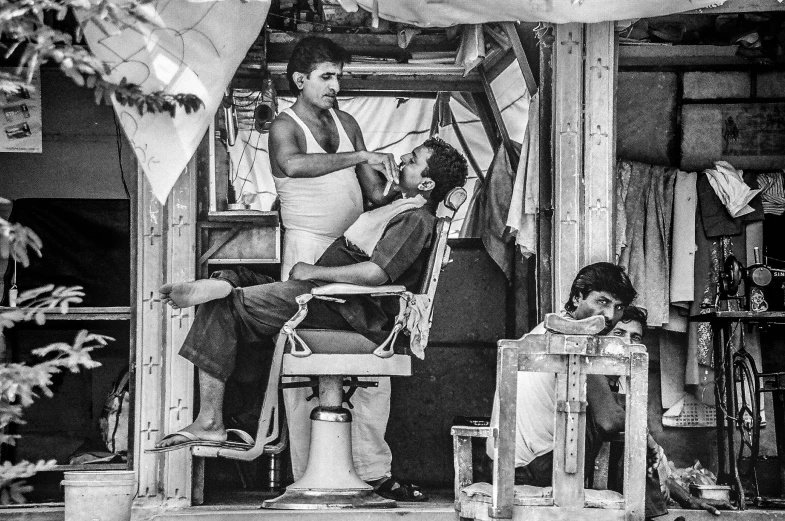 men sitting on a chair in an old building