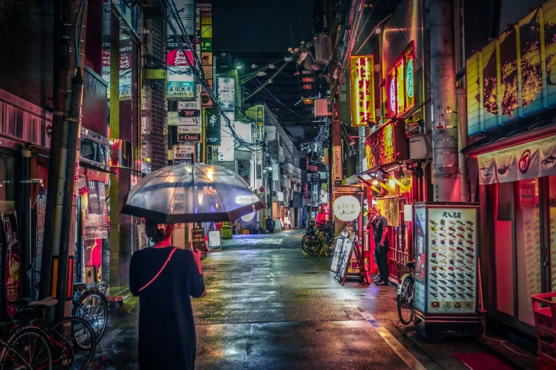 a lady holding an umbrella on a busy city street