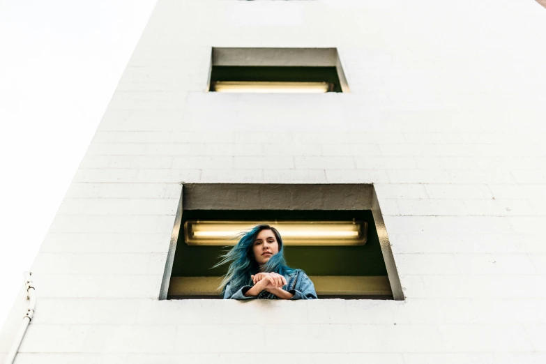 a woman looking out a window in a tower